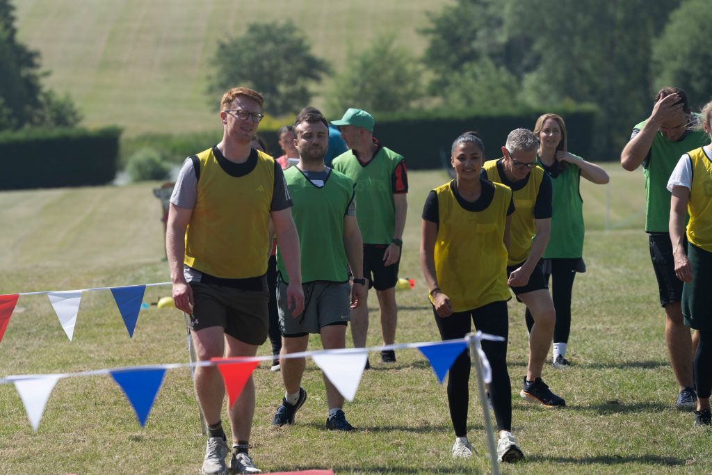 people walking in the field during Battle of Olympus team-building challenge