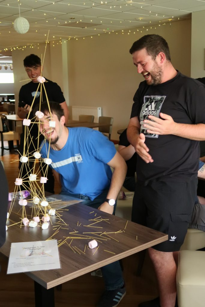 Three men having a laugh by completing their task